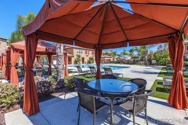 view of patio with a gazebo and outdoor dining area