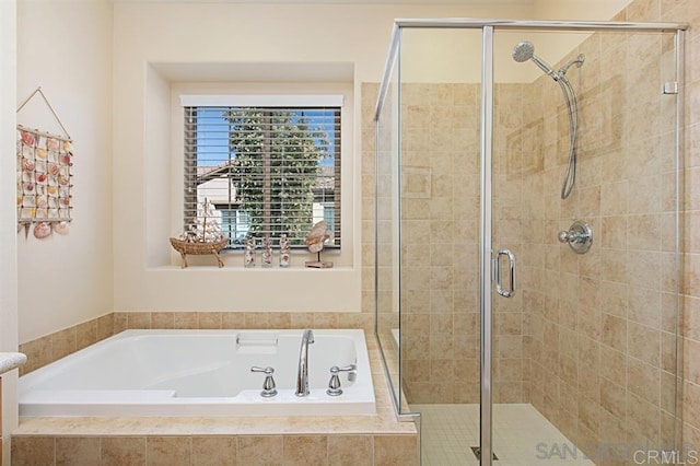 full bath with a shower stall and a garden tub