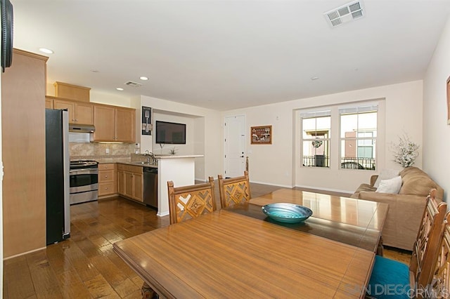 dining room featuring dark wood finished floors and recessed lighting