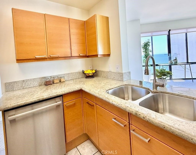 1310 E Ocean Blvd E Unit 1001, Long Beach, CA 90802 - kitchen featuring stainless steel dishwasher, a sink, light stone countertops, and light tile patterned floors