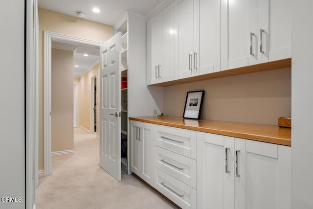 hallway with light carpet, recessed lighting, and baseboards