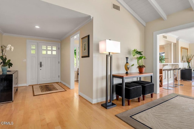 entryway featuring light wood-style floors, baseboards, crown molding, recessed lighting, and beam ceiling