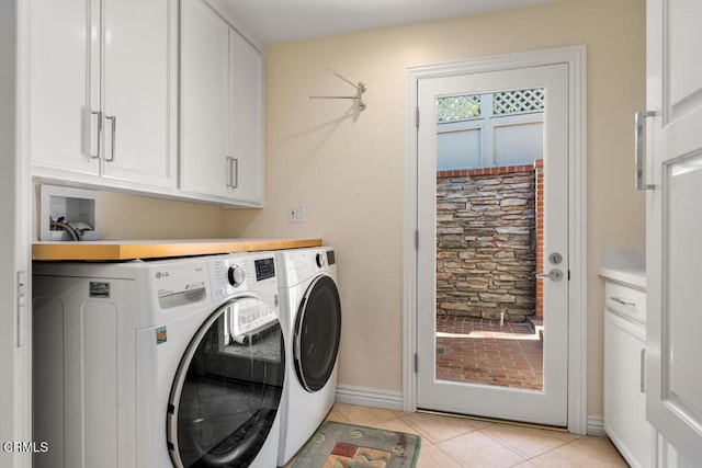 laundry room with cabinet space, washing machine and clothes dryer, light tile patterned flooring, and baseboards