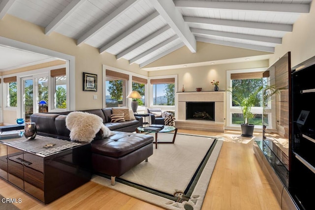 living area featuring light wood-style floors, a high end fireplace, and french doors
