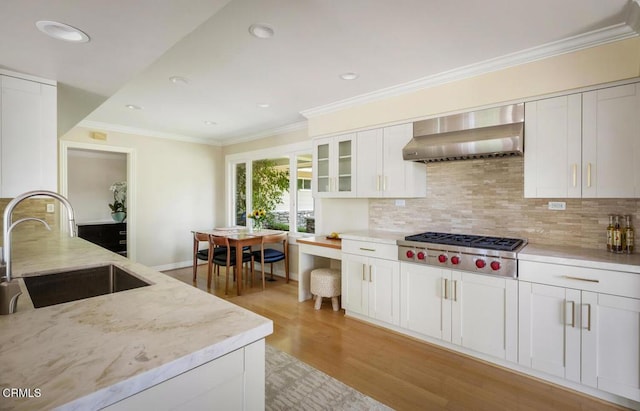 5109 Redwillow Ln, La Canada Flintridge, CA 91011 - kitchen with stainless steel gas stovetop, wall chimney range hood, light wood finished floors, decorative backsplash, and light stone counters