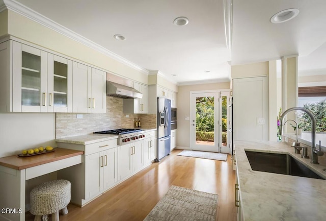 5109 Redwillow Ln, La Canada Flintridge, CA 91011 - kitchen with wall chimney range hood, healthy amount of natural light, ornamental molding, light wood-style floors, and light stone counters