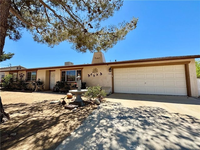 7442 Camarilla Ave, Yucca Valley, CA 92284 - ranch-style home featuring concrete driveway, stucco siding, and a garage