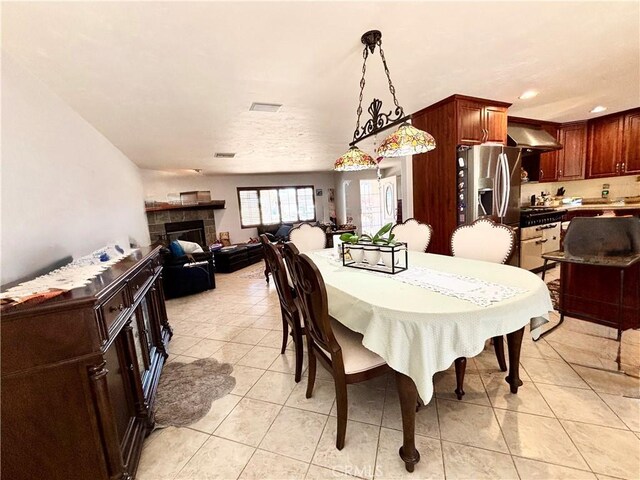 7442 Camarilla Ave, Yucca Valley, CA 92284 - dining space featuring light tile patterned flooring, a fireplace, and recessed lighting