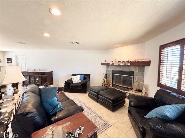 7442 Camarilla Ave, Yucca Valley, CA 92284 - living room with light tile patterned flooring, a stone fireplace, and recessed lighting