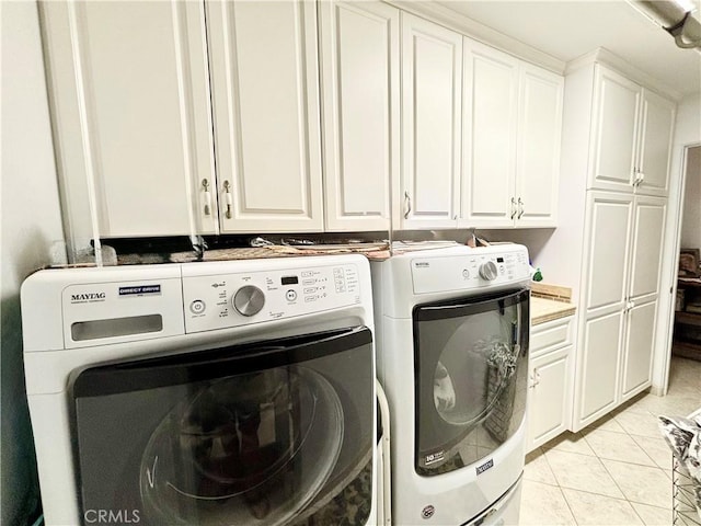 7442 Camarilla Ave, Yucca Valley, CA 92284 - washroom with washing machine and clothes dryer, cabinet space, and light tile patterned floors