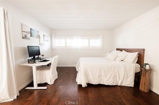bedroom featuring dark wood-type flooring and baseboards