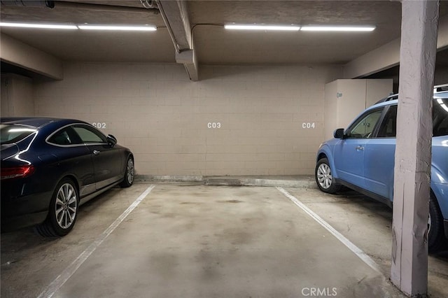 parking deck featuring concrete block wall