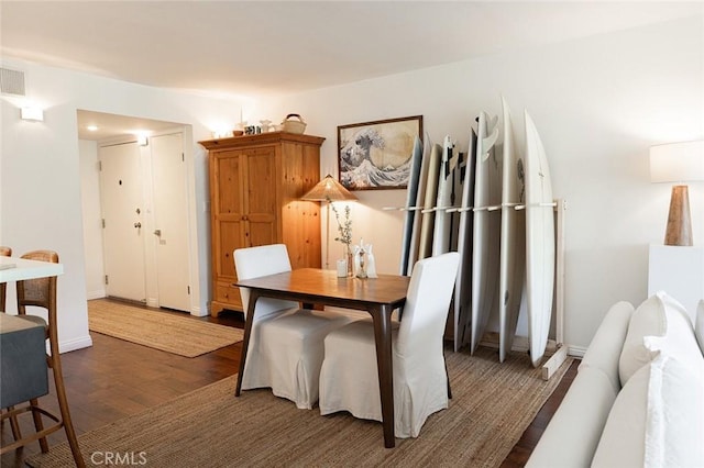 dining area featuring wood finished floors and baseboards