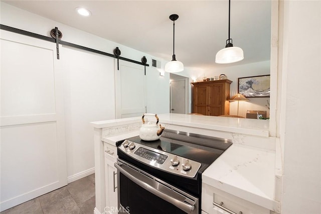 kitchen with electric range, a barn door, white cabinets, pendant lighting, and recessed lighting