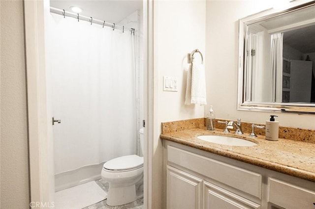 bathroom with toilet, vanity, and a shower with shower curtain