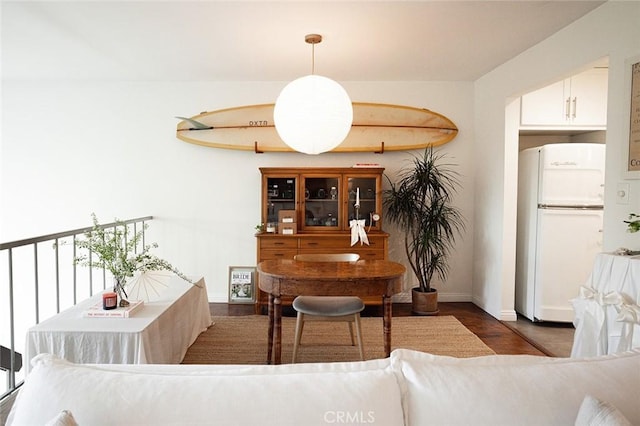 dining area with wood finished floors and baseboards