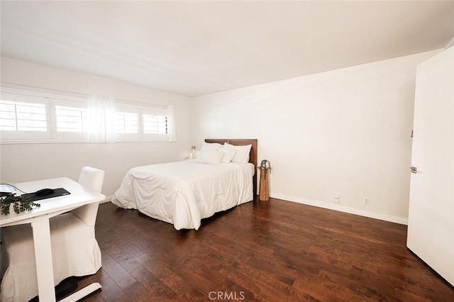 bedroom featuring dark wood-style flooring and baseboards