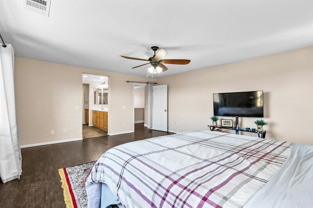 bedroom with dark wood-type flooring, baseboards, ceiling fan, and ensuite bathroom