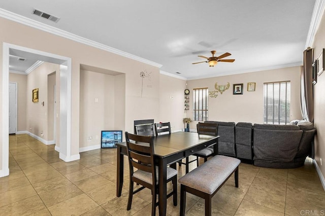 dining area featuring crown molding, a ceiling fan, baseboards, and light tile patterned flooring