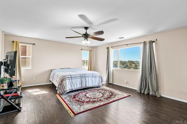 bedroom with baseboards, wood finished floors, and a ceiling fan