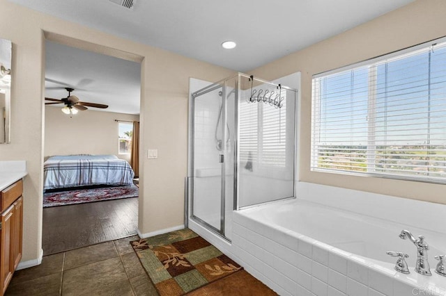 bathroom with connected bathroom, a shower stall, tile patterned floors, a garden tub, and recessed lighting