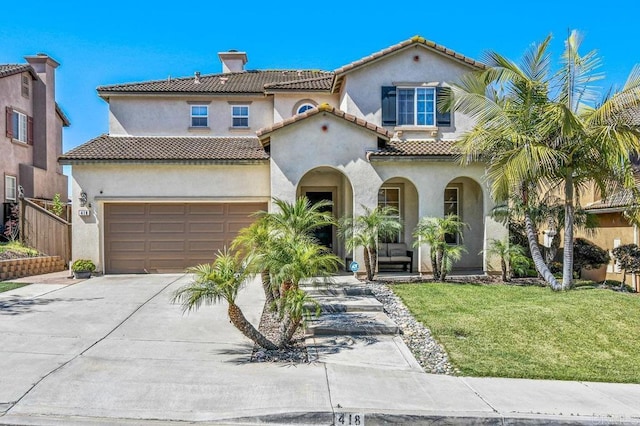 mediterranean / spanish home featuring concrete driveway, a garage, stucco siding, and a tiled roof