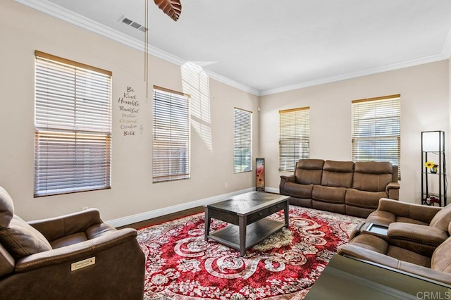 living area featuring ornamental molding, baseboards, and wood finished floors