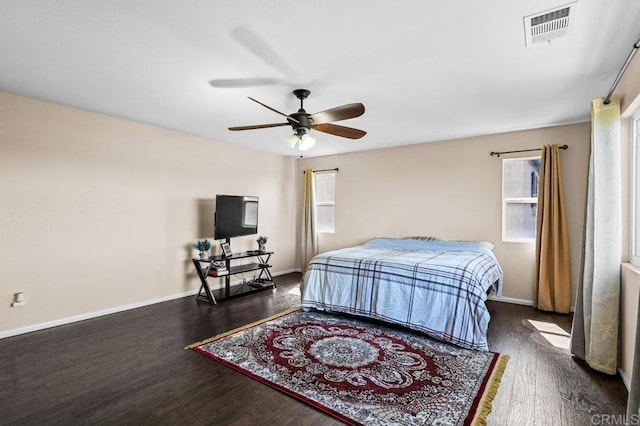 bedroom featuring wood finished floors, baseboards, and ceiling fan