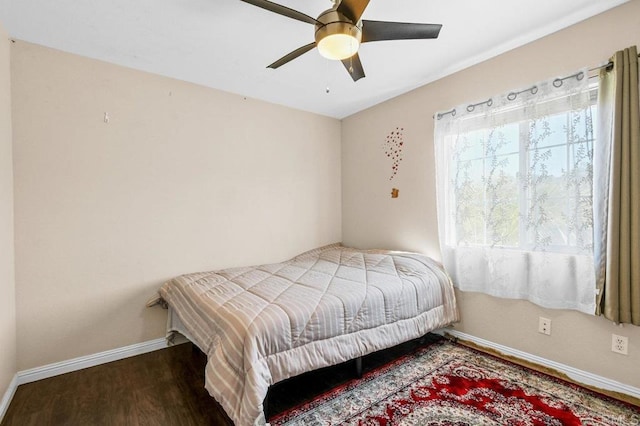 bedroom with baseboards, wood finished floors, and a ceiling fan