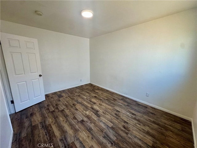 11536 Cimarron Ave, Hawthorne, CA 90250 - spare room with dark wood finished floors, a smoke detector, and baseboards