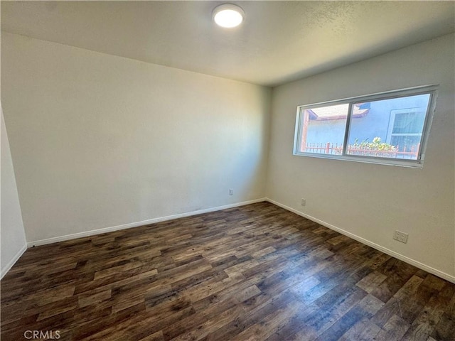11536 Cimarron Ave, Hawthorne, CA 90250 - empty room featuring dark wood-style floors and baseboards