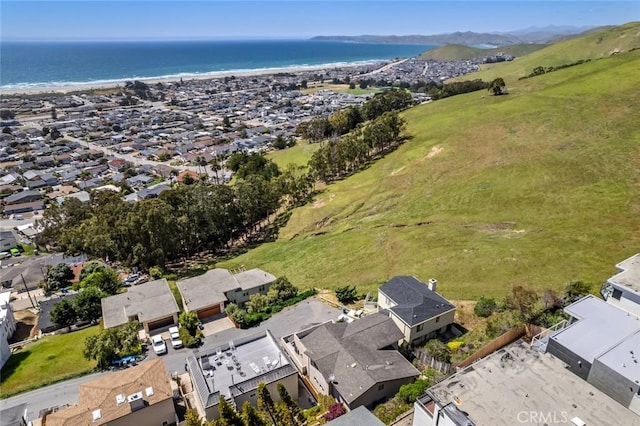 aerial view of residential area featuring a large body of water