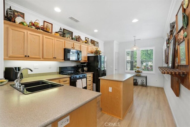 24247 Songsparrow Ln, Corona, CA 92883 - kitchen with black appliances, a sink, a kitchen island, light wood finished floors, and light countertops