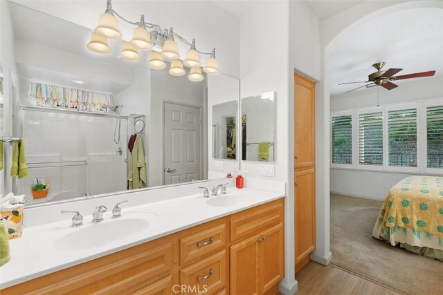 24247 Songsparrow Ln, Corona, CA 92883 - ensuite bathroom with a ceiling fan, wood finished floors, and double vanity
