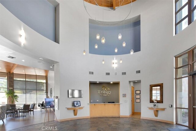 24247 Songsparrow Ln, Corona, CA 92883 - living room featuring a high ceiling, plenty of natural light, and baseboards