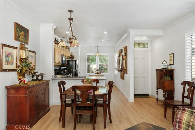 24247 Songsparrow Ln, Corona, CA 92883 - dining area featuring light wood-style floors, crown molding, recessed lighting, and baseboards