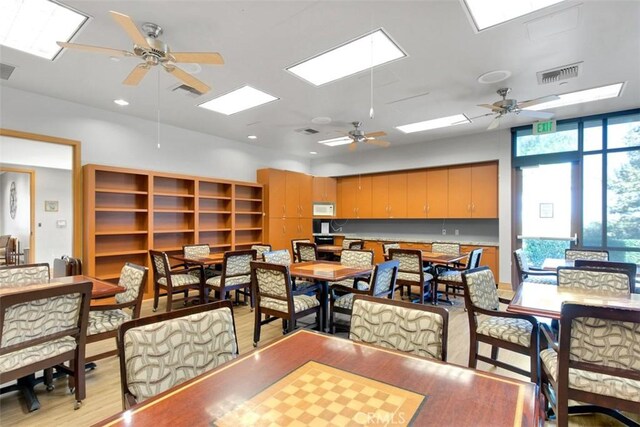24247 Songsparrow Ln, Corona, CA 92883 - dining space with ceiling fan, light wood-style flooring, recessed lighting, and a skylight