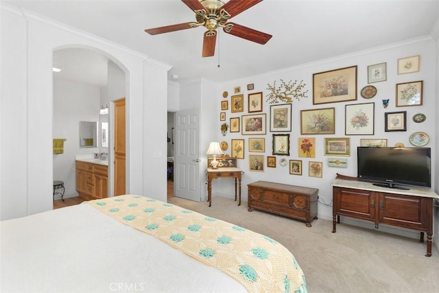24247 Songsparrow Ln, Corona, CA 92883 - bedroom featuring arched walkways, light colored carpet, ensuite bath, crown molding, and a ceiling fan