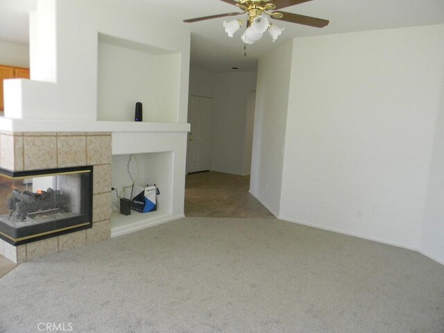 613 Big Spring Dr, Banning, CA 92220 - unfurnished living room with carpet, a ceiling fan, and a fireplace