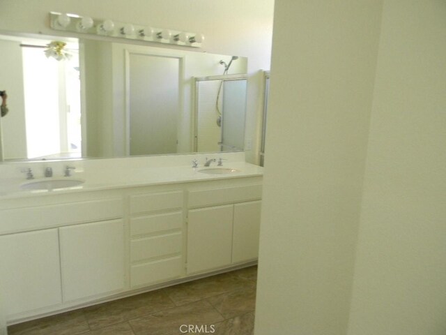 613 Big Spring Dr, Banning, CA 92220 - full bathroom featuring a shower stall and double vanity