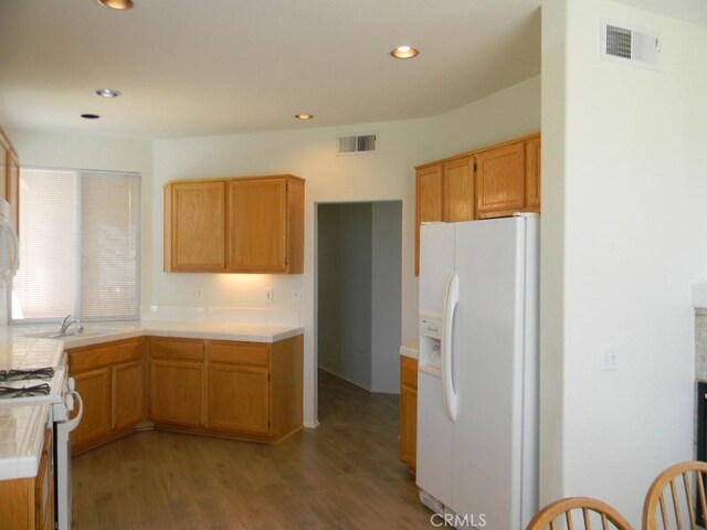 613 Big Spring Dr, Banning, CA 92220 - kitchen with white appliances, tile counters, wood finished floors, a sink, and recessed lighting