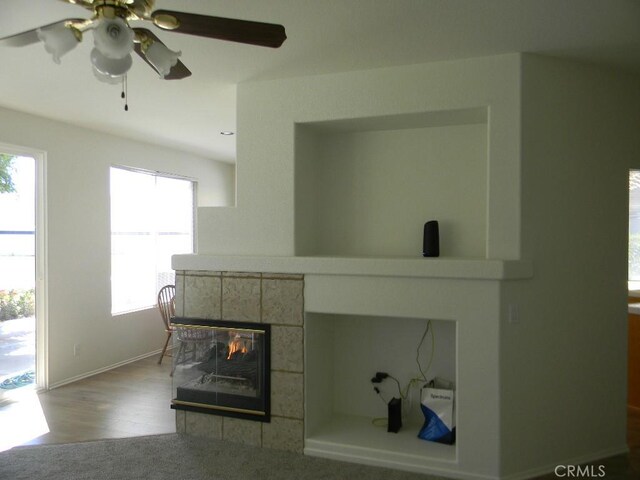 613 Big Spring Dr, Banning, CA 92220 - detailed view of a fireplace, a ceiling fan, wood finished floors, and baseboards