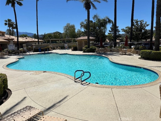 613 Big Spring Dr, Banning, CA 92220 - community pool featuring a patio area and fence