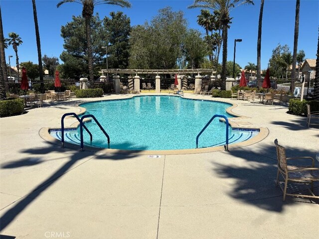 613 Big Spring Dr, Banning, CA 92220 - community pool with a patio area and fence