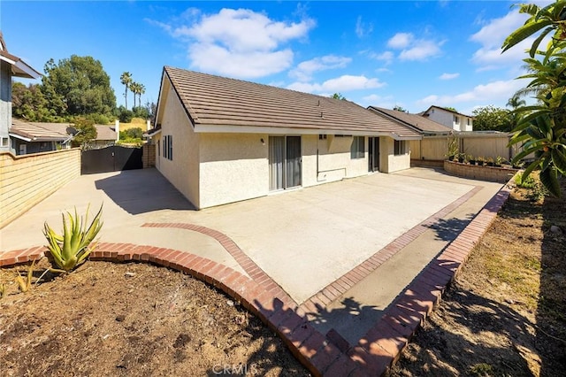 1029 Cogburn Ln, Diamond Bar, CA 91765 - rear view of house with stucco siding, a patio, a fenced backyard, and a tile roof