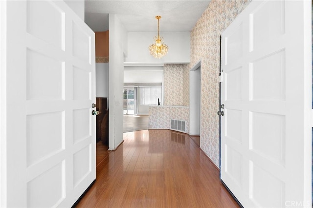 1029 Cogburn Ln, Diamond Bar, CA 91765 - hall with wallpapered walls, a chandelier, and wood finished floors