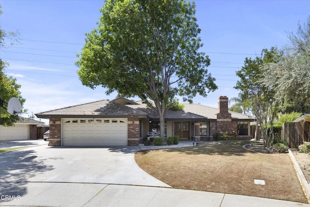 single story home featuring a garage, concrete driveway, brick siding, and a tile roof