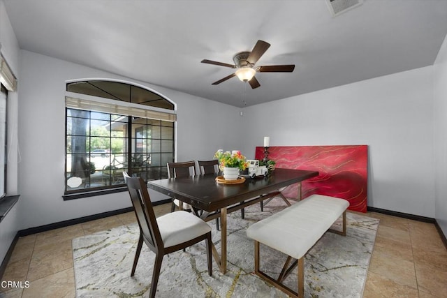 dining area featuring a ceiling fan and baseboards