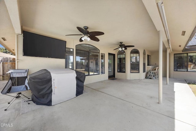 view of patio with ceiling fan and fence