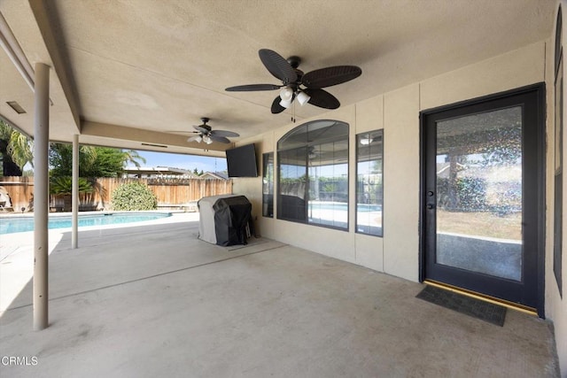 view of patio / terrace with fence, a ceiling fan, and grilling area